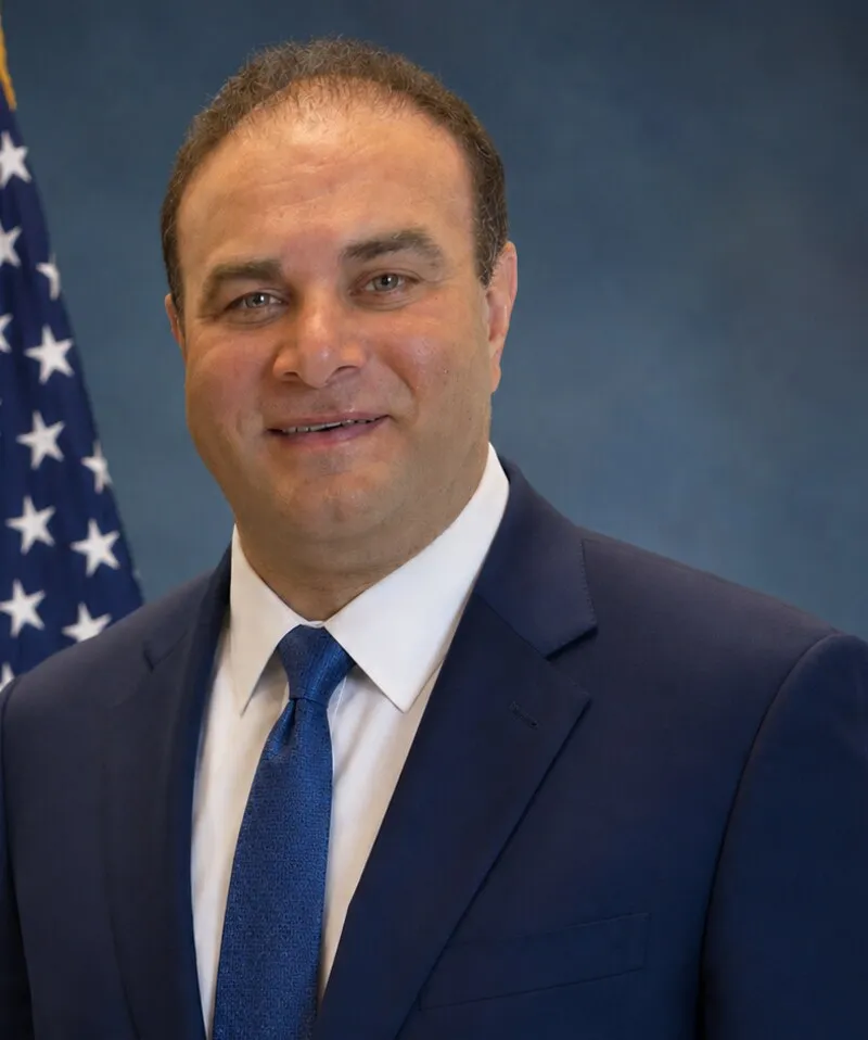 Rod Ganjifard, head and shoulders, in a navy suit.